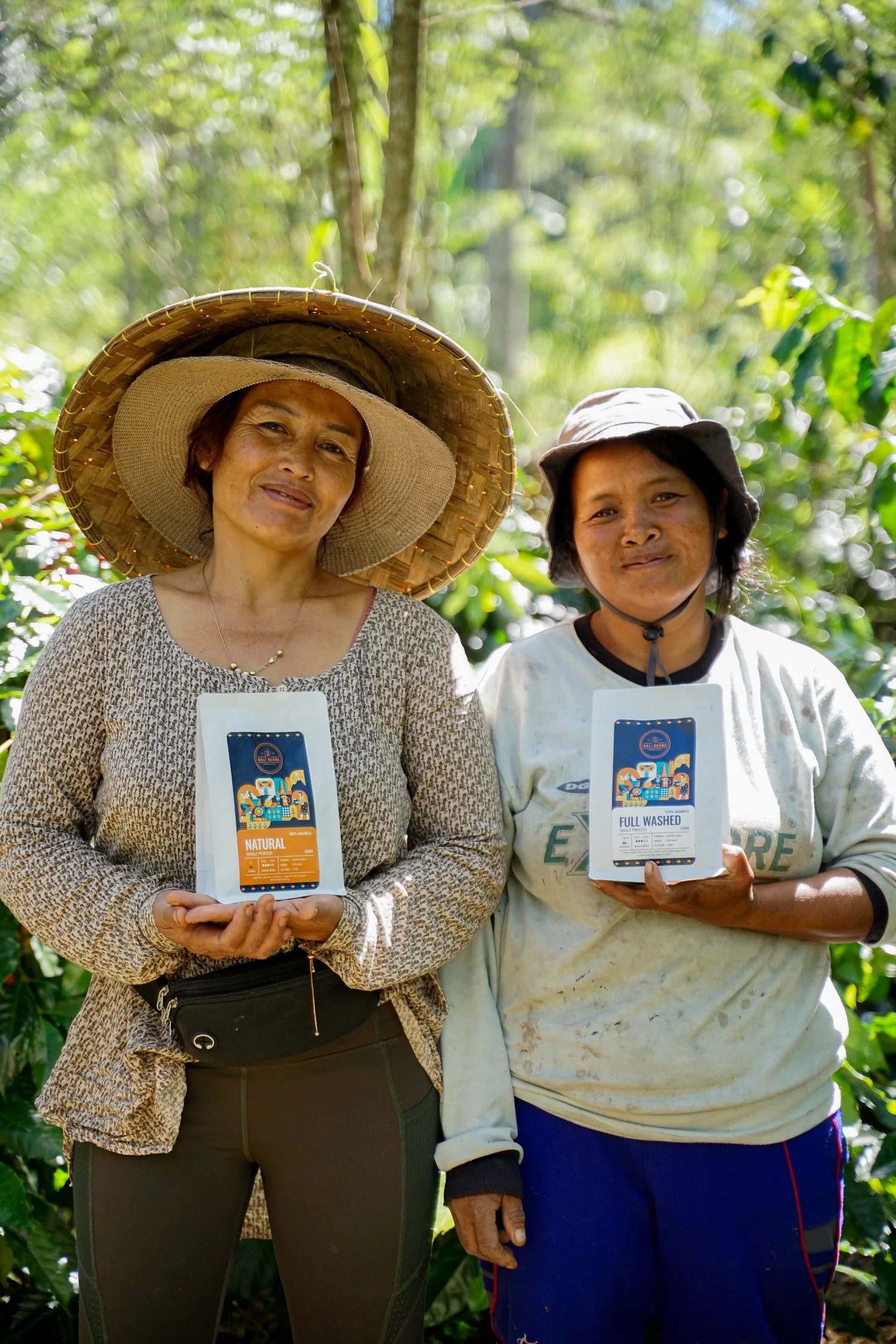Two farmers holding Bali Beans coffee products