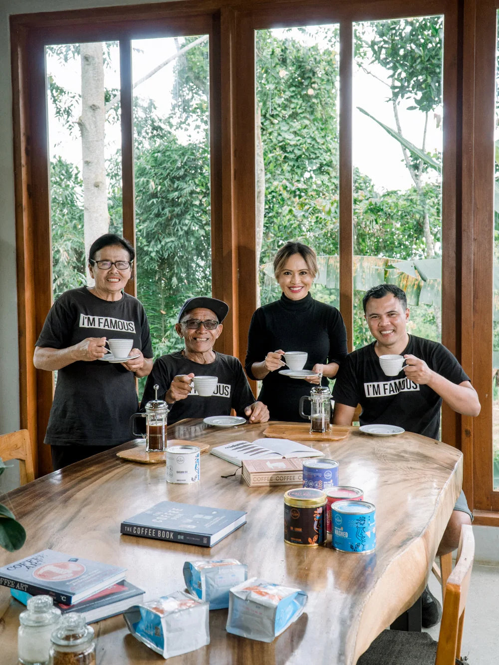 Four people sharing coffee around a table at Bali Beans