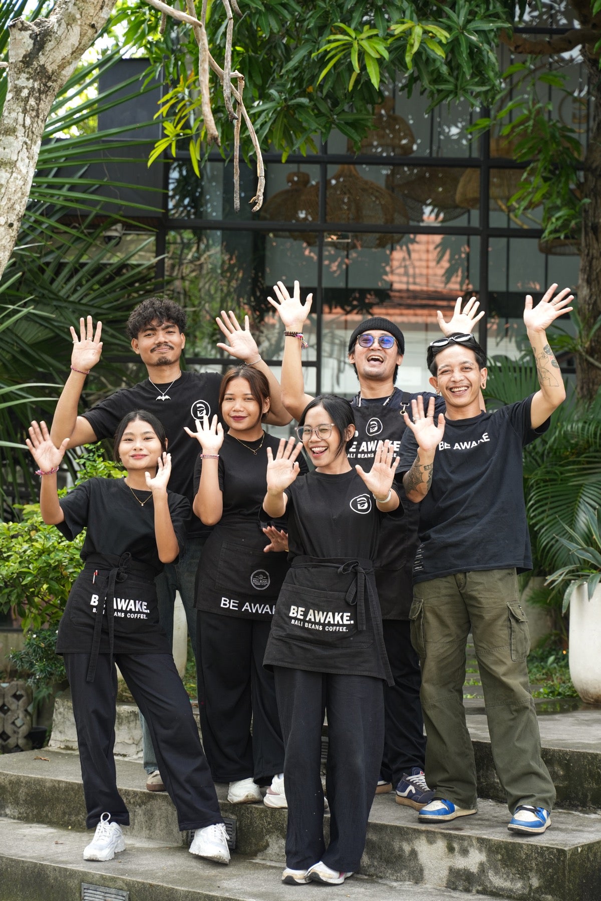 Six Bali Beans team members welcoming visitors outside the café